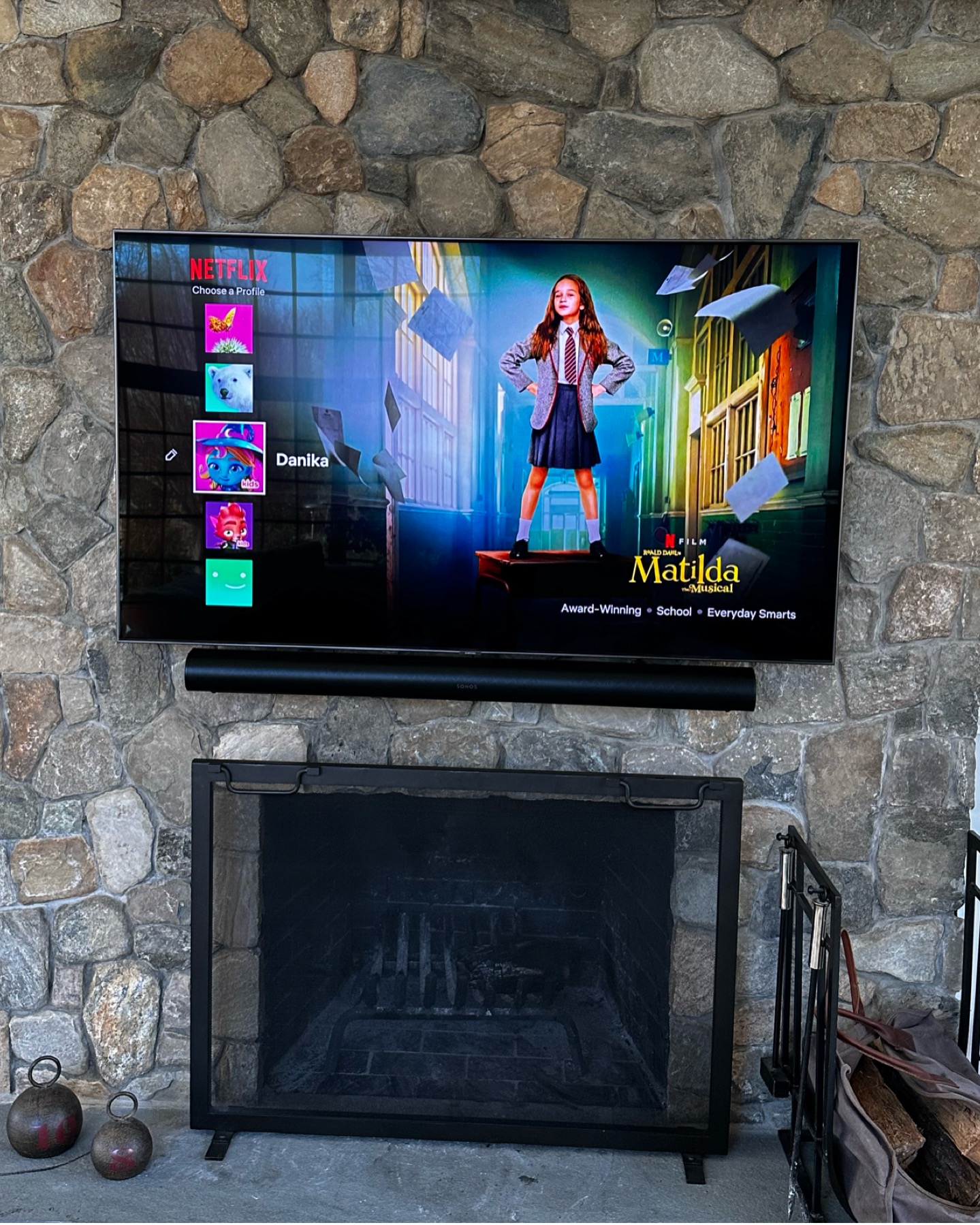 65" TV on stone fireplace with Sonos soundbar